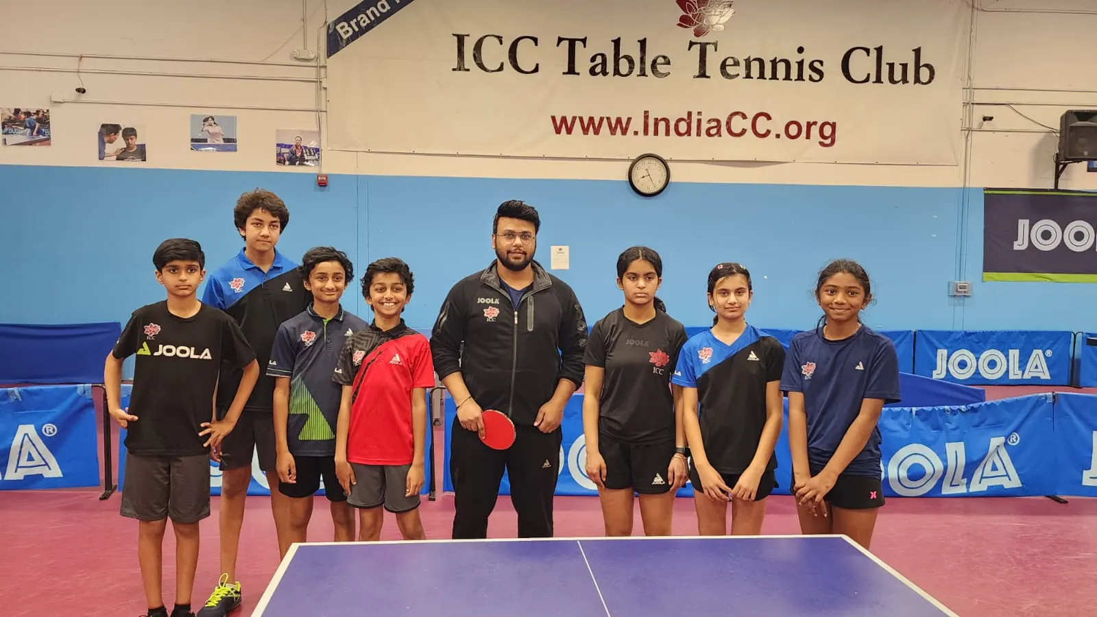 Eight members of the ICC Table Tennis Club squad standing with Subham Kundu